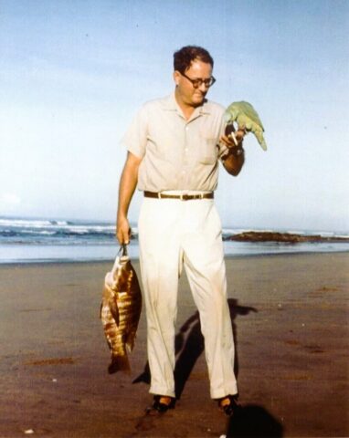 Amb Kennedy M Crockett at Pochomil beach in Nicaragua holding pargo catch and Pancho the parrot. ©KMC