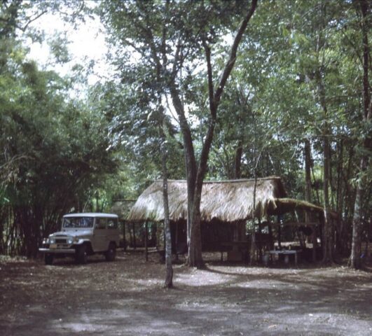 Thatch roof hut and Toyota Landcruiser at El Alamo de San Antonio, Nicaragua, c 1972. ©KMC