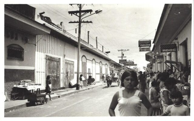 A main street lined with people in the town of Rivas, 1978-1979.