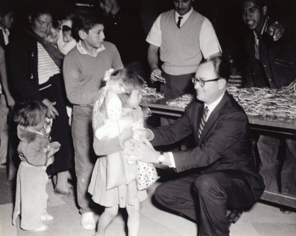 Consul General Kennedy M Crockett greets a little girl who just received a gift, Tijuana Charity, México, 1960. ©KMC