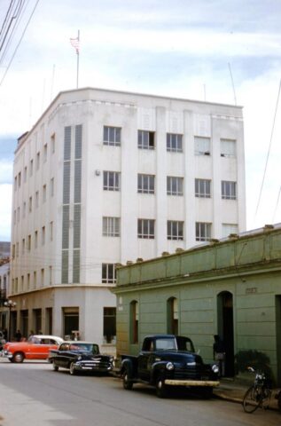A five story white buiding on a main street, the US Embassy, Guatemala City, Guatemala, 1958. ©KMC