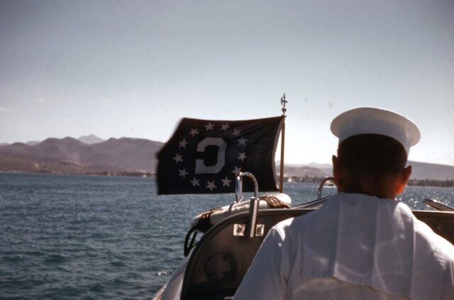 An Admiral's barge displaying the Consul General’s flag at bow traverses the Sea of Cortez, heading to La Paz, Baja California Sur, México, in the Admiral’s Barge, , 1960. ©KMC