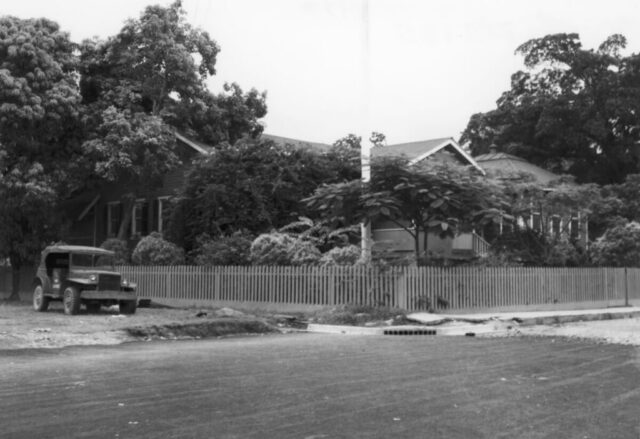 A building in a tropical setting that served as the US Consulate (office and residence) and old jeep left by US Navy after WWII, La Ceiba, Honduras, 1947. ©KMC