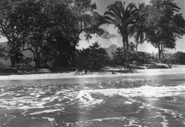 A small group of people are seen on a beautiful tropical beach in La Ceiba, Honduras, 1947. ©KMC