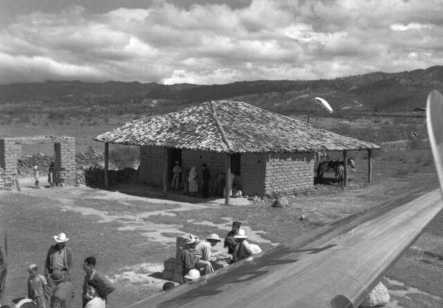 A small tile roofed hut in the middle of nowhere serves as the airport for TACA Airlines in Honduras, 1946. ©KMC
