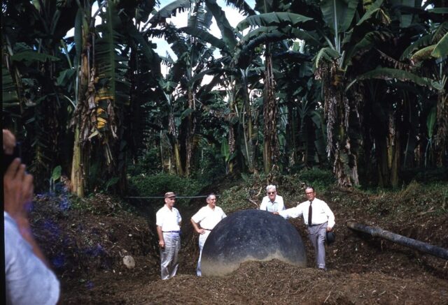 Senator Ellender and United Fruit Company execs with stone sphere uncovered during banana plantation cultivation near Valle del Diquis, Costa Rica, 1958. ©KMC