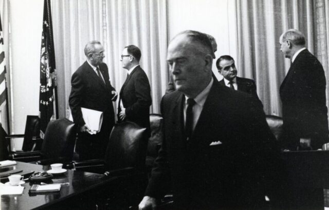 Reviewing the bidding following White House strategy session, 19 May 1965. From L: President Johnson, Kennedy M Crockett, CIA director Adm F Raiburn Jr, Special Asst to President Jack Valenti, Secretary of State Dean Rusk. LBJ Library Okamoto